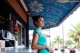 A woman standing at a counter in front of a restaurant.