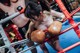 Two women wearing boxing gloves in a boxing ring.