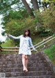 A woman is walking up some steps in a park.