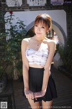 MyGirl Vol.080: Model Yanni (王馨瑶) (57 photos) A woman in a white top and black skirt posing for a picture.